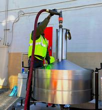 photo of a man holding pump