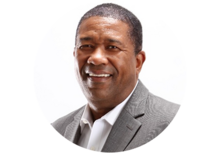 Headshot of Kevin L. Jackson, a man with short black hair, smiling, wearing a white collared shirt and gray suit jacket.