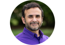 Professional headshot of Raafat Mahmoud Zaini, a man with short black hair, mustache, and beard, wearing a purple collared button up shirt.