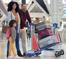 family with luggage at the airport