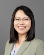 Professional headshot of Ran Tao, a woman with medium length, dark hair and glasses, smiling.
