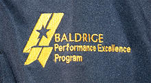 Shop Baldrige EV Women's Run Golf Shirt Logo