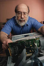 Alan Mink works on a programmable printed circuit board used to process data for the new NIST quantum key distribution system. 