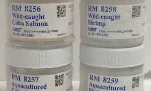 Picture of jars containing reference materials 8256, 8257, 8258, and 8259: Wild caught and aquacultured shrimp and salmon