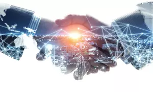 Abstract handshake with a cityscape inside of it.