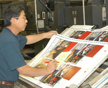 Branch-Smith Printing Division photo of man proofing press sheets.