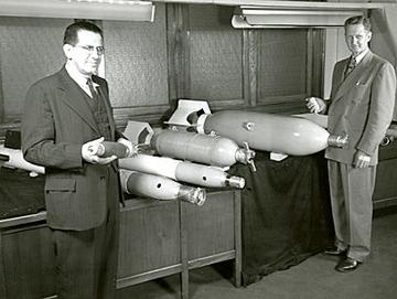 Harry Diamond holds the 81-mm mortar shell with the mortar fuze mounted on the nose.