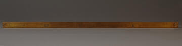 Brass Mexican Vara on gray background