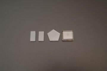 Set of 4 small solid glass weights in rectangle and pentagon shapes 