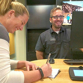 two ECU employees share a laugh in a candid photo