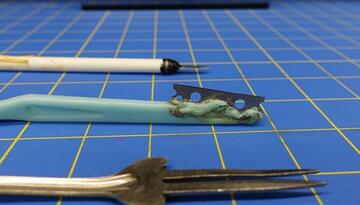 three weapons on a blue checked background
