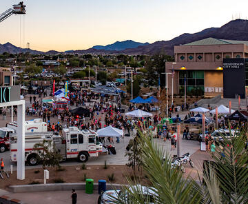 The City of Henderson National Night Out photo showing City Hall, police and rescue services, and vendors with the community enjoying the events.