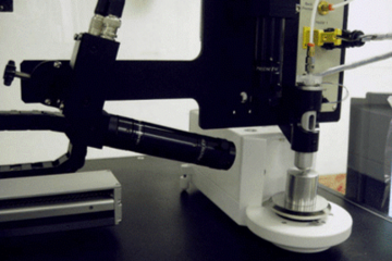 a drop-on-demand dispenser fed by a reservoir of standard solution