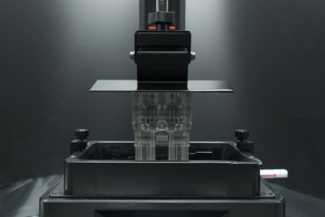 a complex architectural model is being produced by suspension in a vat of photopolymer resin and ultraviolet (UV) curing
