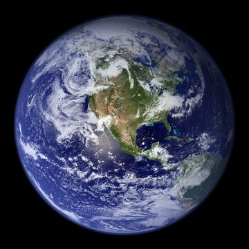 View of Earth from space shows North America and swirling clouds.