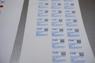 A sheet of square NIST labels saying "Standard Reference Material 1249."