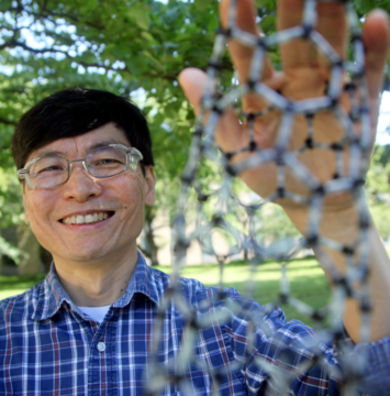 Ming Zheng displays a model of a carbon nanotube, a hybrid molecular structure that can be used as a biosensor.
