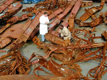 Big pieces of steel with two individuals in the middle