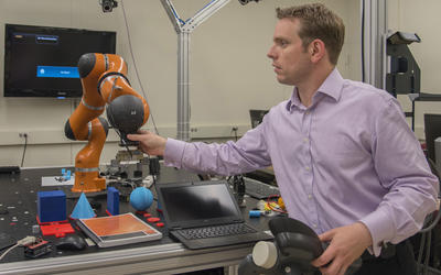 Jeremy Marvel adjusts robotic arm