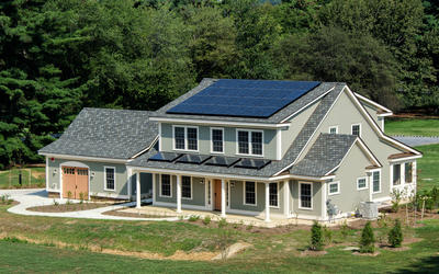 photo of a house. Solar panels on the roof.