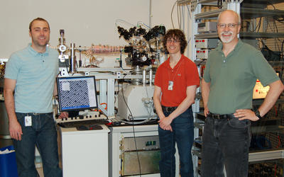 Jabez, McClelland, Adam Steele and Brenton Knuffman pose in their lab with their cesium ion source.