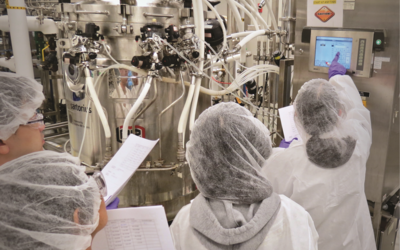 People in clean suits in a bio lab