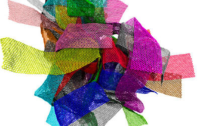 Many different rectangular pieces of webby material are all wrapped up in a big ball. The pieces are each colored differently so that you can tell them apart in the bunch. These are meant to represent a graphene melt.