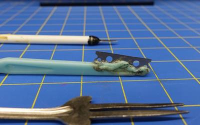 three weapons on a blue checked background
