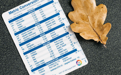 NIST unit conversion card ruler measures an autumn oak leaf