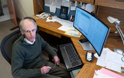 Alexander Kramida looks up as he sits at his desk in front of a computer screen full of data.
