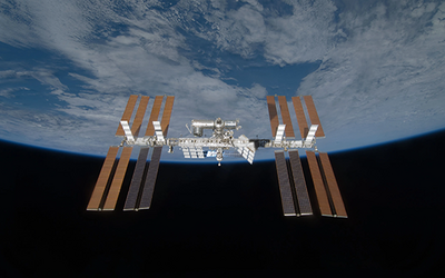 View of the International Space Station with the curve of the Earth in the background. 