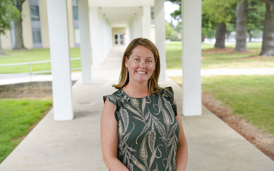 Erica Romsos poses outdoors on the NIST campus. 