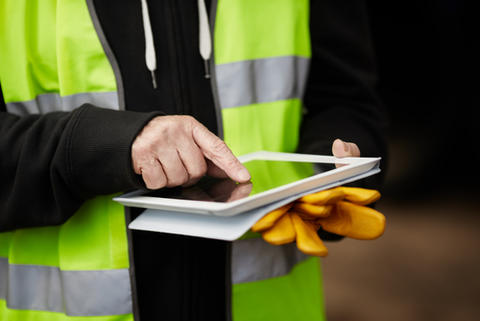 Worker holding electronic device