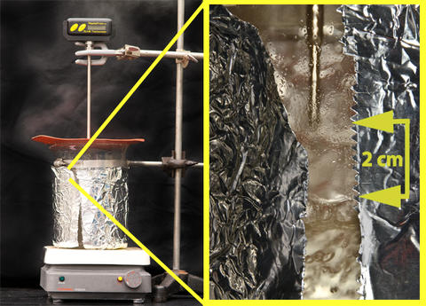 Picture depicting steam verification, with the thermometer tip approximately 2 cm above the boiling water
