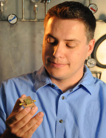NIST research affiliate John Teufel holding his micro drum