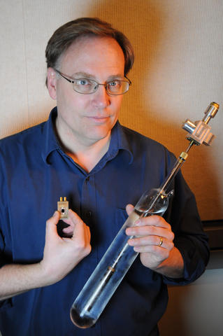 NIST physicist Samuel Benz with the two components that are compared  in the first electronic measurement of the Boltzmann constant. 