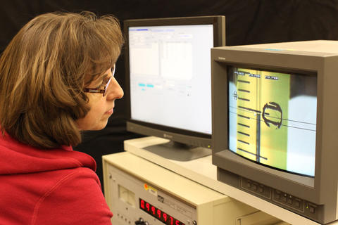 NIST researcher Dawn Cross calibrating a mercury thermometer