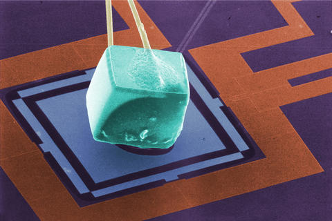 colorized scanning electron micrograph shows a cube of germanium attached to a membrane. 