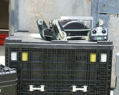 Urban search and rescue robot and its control unit sit atop one of the packing crates 