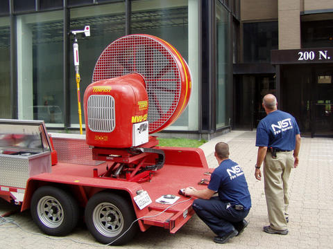 Photo of a mounted fan outside of a building