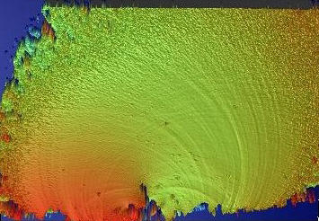 Optical profilometer image of the broken surface of a glass rod shows height of peaks and valleys of the fracture surface in millionths of a meter. 