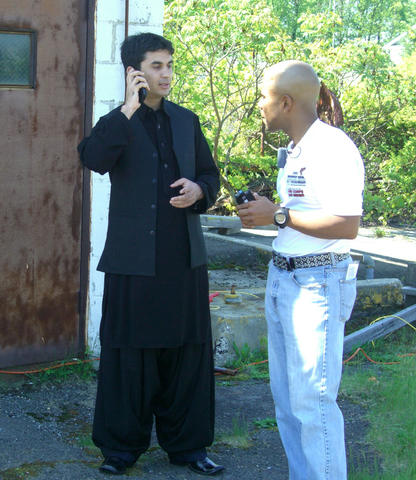 photo of two men using a smart phone voice translation system