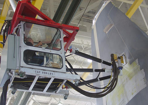 A worker in a protective cab on a NIST-developed revolutionary robotic platform