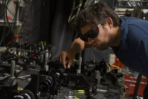 NIST physicist Krister Shalm with the photon source used in the Bell test