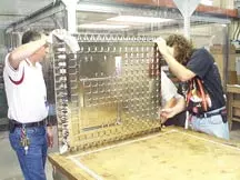 NIST staff members clean the solid aluminum
