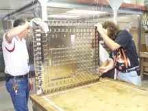 NIST staff members clean the solid aluminum