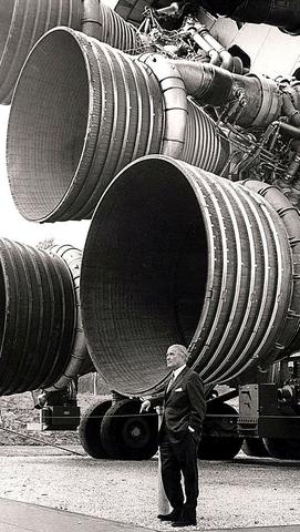 Wernher von Braun standing next to the (very large) F-1 engines.