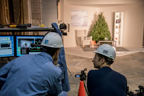 Two engineers observe the scene for the Christmas tree burn