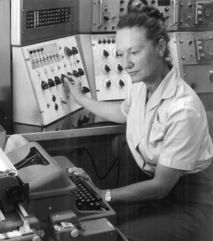 Female researcher sits in front of a computer.
