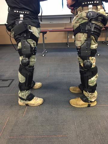 The legs of two soldiers with exoskeletons